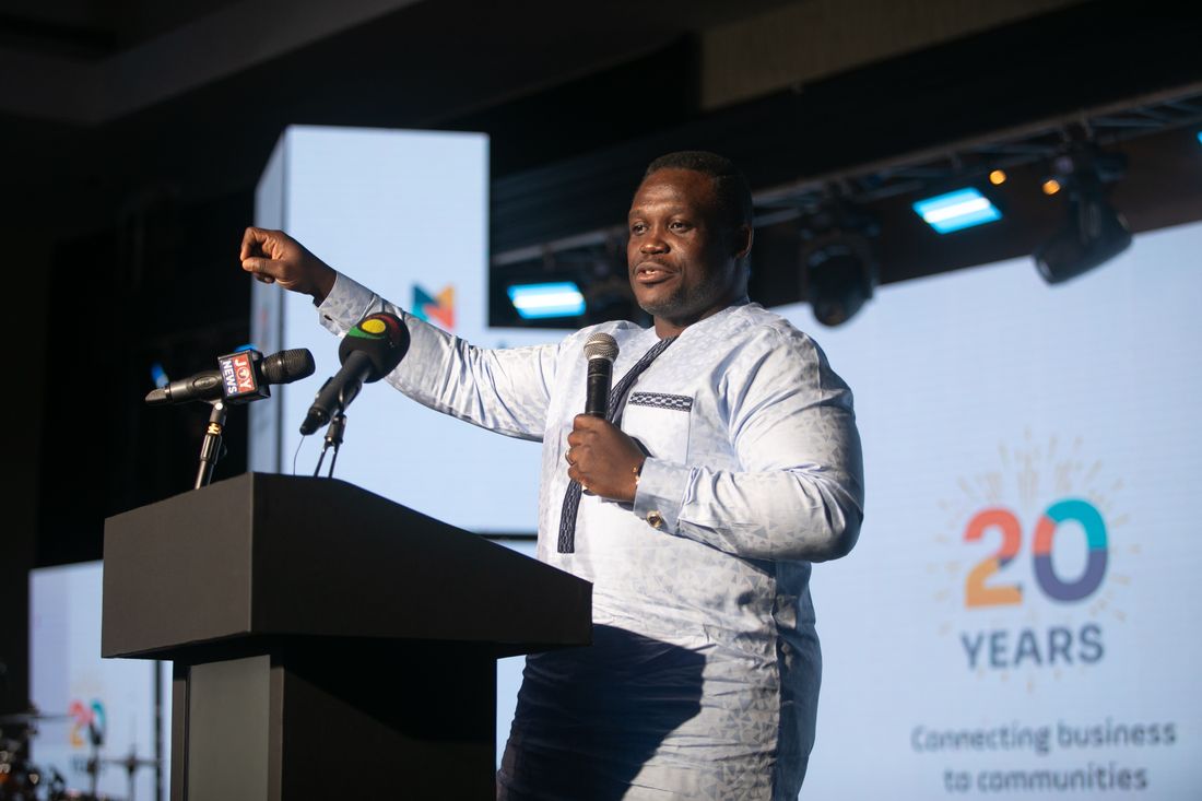 A guest speaker addressing the room from the podium